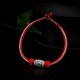 The red string is a symbol of protection, warding off negative energy, and attracting good fortune The red string is a symbol of protection, warding off negative energy, and attracting good fortune