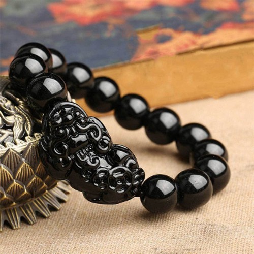 Black Obsidian shields against negativity, while Pixiu attracts wealth and success Black Obsidian shields against negativity, while Pixiu attracts wealth and success